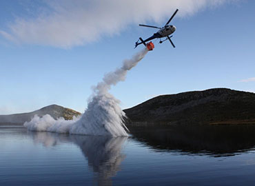 Helicopter aerial spreading of fertiliser and lime